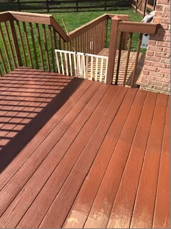 Deck boards being recoated near the stairs