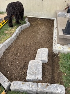 Prepared landing area with edging stones and Roscoe beside it