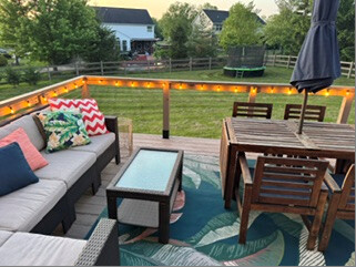 Furnished deck with illuminated wire railing